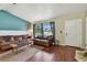 Comfortable living room featuring hardwood floors, large windows, and neutral paint at 1707 Cardinal Dr, Clearwater, FL 33759