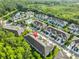 A high angle of townhomes within a planned community, surrounded by mature trees and greenery at 17834 Althea Blue Pl, Lutz, FL 33558
