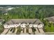 A high angle view of modern townhomes surrounded by a dense forest canopy at 17834 Althea Blue Pl, Lutz, FL 33558