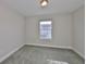Comfortable bedroom with soft carpet, and a bright window offering natural light at 17834 Althea Blue Pl, Lutz, FL 33558