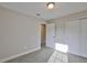 Bedroom with neutral walls, carpeted floor, and a closet for storage at 17834 Althea Blue Pl, Lutz, FL 33558