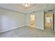 Light-filled bedroom with neutral carpet and easy access to bathroom and hall at 17834 Althea Blue Pl, Lutz, FL 33558