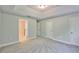 Light-filled bedroom with neutral carpet, multiple doors and access to a bathroom at 17834 Althea Blue Pl, Lutz, FL 33558
