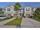 Charming townhome with a well-manicured lawn, brown shutters, and a palm tree in the yard at 17834 Althea Blue Pl, Lutz, FL 33558
