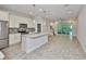 Bright open-concept kitchen featuring granite counters, stainless appliances and wood-look tile floors at 17834 Althea Blue Pl, Lutz, FL 33558