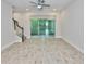 The bright living room features sliding glass doors to the outside and a staircase leading to the second floor at 17834 Althea Blue Pl, Lutz, FL 33558