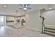 Spacious living space combining the living, dining, and kitchen areas with a staircase to the second level at 17834 Althea Blue Pl, Lutz, FL 33558
