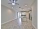 Open-concept living space showcases the kitchen and living area, featuring wood-look tile floors and ample natural light at 17834 Althea Blue Pl, Lutz, FL 33558