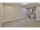 Large loft space with neutral carpet, railing, and a staircase leading to another level at 17834 Althea Blue Pl, Lutz, FL 33558