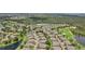 Expansive aerial view of a residential community with lush landscaping, a golf course, and scenic water features at 2032 Inverness Greens Dr # 76, Sun City Center, FL 33573