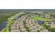Scenic aerial view showcases a community with golf course, lakes, and manicured landscaping at 2032 Inverness Greens Dr # 76, Sun City Center, FL 33573