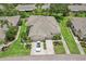 A birds-eye view of a well-maintained property featuring lush greenery, a two-car garage, and a well-manicured lawn at 2032 Inverness Greens Dr # 76, Sun City Center, FL 33573