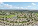Wide aerial view of sprawling residential community with golf course, ponds and manicured landscaping at 2032 Inverness Greens Dr # 76, Sun City Center, FL 33573