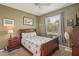 Cozy bedroom featuring neutral walls, a ceiling fan, and a bright window at 2032 Inverness Greens Dr # 76, Sun City Center, FL 33573
