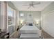 Bright bedroom featuring a ceiling fan, window, and neutral walls, creating a serene and inviting atmosphere at 2032 Inverness Greens Dr # 76, Sun City Center, FL 33573