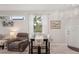 Open dining area featuring a modern table set, pendant lighting, and stylish decor next to the living room at 2032 Inverness Greens Dr # 76, Sun City Center, FL 33573