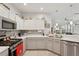 Bright, modern kitchen with stainless steel appliances, light countertops, and a stylish backsplash at 2032 Inverness Greens Dr # 76, Sun City Center, FL 33573