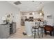 Stylish kitchen featuring modern appliances, white cabinetry, a breakfast bar, and decor accents at 2032 Inverness Greens Dr # 76, Sun City Center, FL 33573