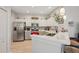 Well-equipped kitchen with stainless steel appliances, white cabinetry, and stylish backsplash at 2032 Inverness Greens Dr # 76, Sun City Center, FL 33573