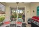 Cozy screened lanai with comfortable seating and a BBQ grill, perfect for outdoor entertaining at 2032 Inverness Greens Dr # 76, Sun City Center, FL 33573