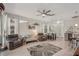 Bright living room with wood floors, comfortable seating, ceiling fan, and natural light from large windows at 2032 Inverness Greens Dr # 76, Sun City Center, FL 33573