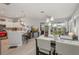Bright open-plan living space with kitchen, dining, and seating areas connected at 2032 Inverness Greens Dr # 76, Sun City Center, FL 33573