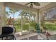 Relaxing screened patio featuring outdoor seating, grill, and a view of the lush backyard at 2032 Inverness Greens Dr # 76, Sun City Center, FL 33573