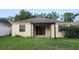 Backyard view of home with patio area and lawn at 221 Fairmont Dr, Spring Hill, FL 34609