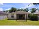 Backyard view of home featuring a covered patio and privacy fence at 221 Fairmont Dr, Spring Hill, FL 34609