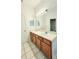 Bright bathroom with double sink vanity, large mirror, and tile flooring at 221 Fairmont Dr, Spring Hill, FL 34609