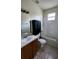 Bathroom with vanity, wood cabinets, a tub and shower combo, and neutral tile at 221 Fairmont Dr, Spring Hill, FL 34609