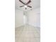 Spacious bedroom with tile floors, ceiling fan, and closet at 221 Fairmont Dr, Spring Hill, FL 34609