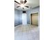 Bedroom features tile flooring, ceiling fan, and closet space at 221 Fairmont Dr, Spring Hill, FL 34609