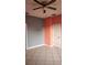 Spacious bedroom featuring neutral tile floors and a ceiling fan for added comfort at 221 Fairmont Dr, Spring Hill, FL 34609