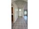 Inviting entryway with tile flooring, high ceilings, and arched doorways, offering a warm welcome at 221 Fairmont Dr, Spring Hill, FL 34609