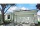 Charming two-story home with a two-car garage, mature trees, and a well-maintained lawn at 221 Fairmont Dr, Spring Hill, FL 34609