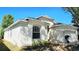 Charming single-Gathering home with a well-maintained stucco exterior and beautiful landscaping at 221 Fairmont Dr, Spring Hill, FL 34609