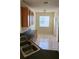 Kitchen features wood cabinets, tile floors, and black countertop with eat in dining space at 221 Fairmont Dr, Spring Hill, FL 34609