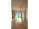 Bright living room with tile flooring and a large sliding glass door that offers backyard views at 221 Fairmont Dr, Spring Hill, FL 34609