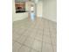 Spacious room showcasing tiled floors, and an open layout leading to kitchen area at 221 Fairmont Dr, Spring Hill, FL 34609