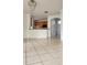 Open-concept living area with tile flooring, blending seamlessly with the kitchen and entryway at 221 Fairmont Dr, Spring Hill, FL 34609