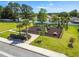 Community playground with modern play structures, black fence, picnic tables and tropical landscaping at 221 Fairmont Dr, Spring Hill, FL 34609