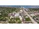 Aerial view of a community building surrounded by lush trees, with a water view in the distance at 2525 W Bay Dr # B43, Belleair Bluffs, FL 33770