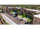 Aerial view of condo building featuring pool, shuffleboard, manicured lawns and parking at 2525 W Bay Dr # B43, Belleair Bluffs, FL 33770