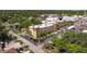 Aerial view of condo building featuring a parking lot and lots of beautiful trees at 2525 W Bay Dr # B43, Belleair Bluffs, FL 33770