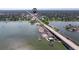 Scenic aerial view of a bridge over a calm body of water with a boat ramp at 2525 W Bay Dr # B43, Belleair Bluffs, FL 33770