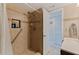 Bathroom featuring a tiled shower with built-in niche and grab bar, along with neutral tones at 2525 W Bay Dr # B43, Belleair Bluffs, FL 33770