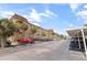 Beige two-story condominium complex with palm trees, parking spaces, and blue skies on a sunny day at 2525 W Bay Dr # B43, Belleair Bluffs, FL 33770