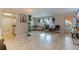 Bright living room with tile floors, comfortable seating, and access to a balcony with an archway at 2525 W Bay Dr # B43, Belleair Bluffs, FL 33770
