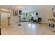Well-lit living room features tiled floors, comfortable sofa, hanging plants, and lots of natural light at 2525 W Bay Dr # B43, Belleair Bluffs, FL 33770